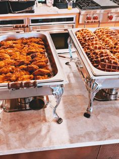 two trays of fried chicken and waffles are on display in the kitchen