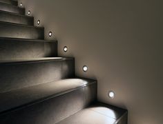 some lights that are on the side of some stairs