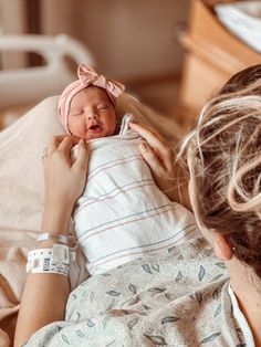 a woman holding a baby in her arms