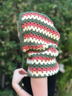 a woman wearing a crocheted hat and scarf