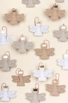 paper angel ornaments hanging on a wall