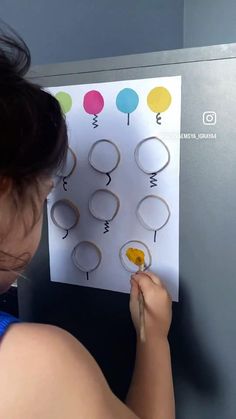 a young woman is working on some type of crafting project with paper and scissors