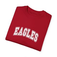 Show your Eagles pride with this classic t-shirt featuring bold, collegiate-style lettering. Perfect for game days, school events, or everyday wear, this tee lets you confidently represent your team. The clean and straightforward design makes it a versatile addition to any fan’s wardrobe. Cheer on the Eagles in style, and let everyone know who you’re supporting with this timeless team t-shirt. College Fan Apparel T-shirt With Team Name, College Varsity T-shirt With Graphic Print, Collegiate Game Day T-shirt With Team Name, Collegiate T-shirt With University Logo For Game Day, Varsity T-shirt With Team Logo For Football Season, Sporty University Logo T-shirt With Crew Neck, Game Day University Logo T-shirt, College Football Season T-shirt With Team Logo, Varsity T-shirt For College Football Season