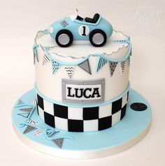 a blue and white cake with a car on top