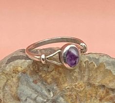 Sterling Silver vintage ring with an oval, bezel set bandedAmethyst cabochon in shades of purple. This pretty, boho style solid silver ring has split shoulders and is stamped SIL for silver.  Good vintage condition  UK size N, US size 7  The stone measures 7 x 5 mm Weight 2g Please study the photographs where I try to show as much detail as possible. Any damage or obvious imperfections will be clearly stated. I offer FREE SHIPPING on all of my listings so the price you see is the price you pay! Collectible Oval Cabochon Amethyst Ring, Vintage Amethyst Rings With Polished Finish, Vintage Adjustable Amethyst Ring In Sterling Silver, Classic Oval Cabochon Amethyst Jewelry, Adjustable Vintage Sterling Silver Amethyst Ring, Oval Amethyst Cabochon Ring, Vintage Oval Amethyst Birthstone Ring, Classic Silver Amethyst Ring Oval Cabochon, Classic Silver Amethyst Oval Cabochon Ring