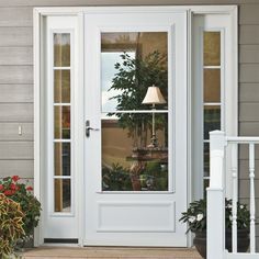 a white front door with a lamp and potted plants