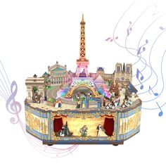 a musical box with an image of the eiffel tower on top and music notes around it