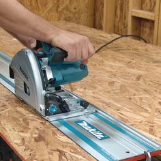 a person using a circular saw to cut wood with a jig blade on a table