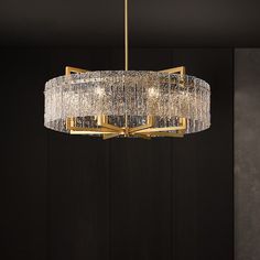 a chandelier hanging from the ceiling in a room with black walls and flooring