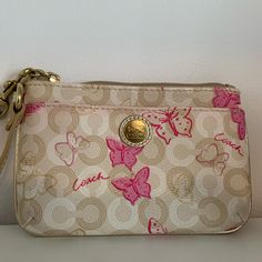 Beige, Cream And Gold Small Coach Wristlet With Butterfly Pattern. Gold Leather Strap, Pink Satin Fabric In The Inside, Zipper Closure. (6 X 4 X .75 Inches) Like New Condition, Never Used Butterfly Coach Bag, Pink Clutch Wristlet As A Gift, Pink Wristlet With Removable Pouch As Gift, Pink Clutch Wristlet, Pink Clutch Wristlet With Zipper Closure, Chic Pink Wristlet For Everyday Use, Chic Pink Wristlet For Gift, Pink Pouch Wristlet With Zipper Closure, Pink Wristlet With Removable Pouch