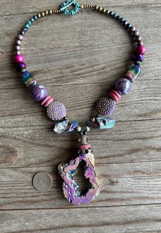 Beautiful colors in this necklace!  Perfect for Fall and Winter sweaters.  The pendant and beads seem to change colors as they move.  A stunning conversation piece.  An absolute one-of-a-kind piece! Unique Purple Gemstone Bead Necklaces, Unique Purple Beaded Necklaces For Crafting, One Of A Kind Multicolor Healing Necklaces, Unique One Of A Kind Purple Necklace, Unique Purple Gemstone Beaded Necklaces, Colorful Beaded Pendant Necklace, Unique Beaded Crystal Necklaces, Unique Multicolor Pendant Crystal Necklace, Unique Colorful Beaded Pendant Necklace