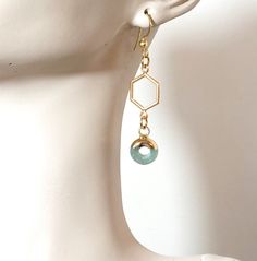 Aventurine Stone earrings with donut figure and gold bath. The hooks and metal are stainless steel 📏 Length of earrings 7 cm. 🔮 THERAPEUTIC PROPERTIES OF AVENTURINE (Aventurine is associated with the Heart chakra) (Stone of Taurus) 🔹Provides balance between mind and body, providing stability and emotional calm 🔹Psychologically reinforces the qualities of leadership and decision. Promotes compassion and empathy while favoring perseverance. 🔹 At the healing level, Aventurine is often used as an anti-inflammatory, for skin ailments and for the eyes. 💎M A T E R I A L S ▪️ Round Aventurine stone and gold bath. ▪️Golden steel hexagonal pendant. ▪️ Golden stainless steel hooks. PACKAGING + SHIPPING 🎁 Very nice and elegant packaging, ready to give away if desired. An explanatory card of the Gold Bad, Please Talk To Me, Aventurine Jewelry, Gold Bath, Aventurine Stone, Leadership Qualities, Chakra Stones, Stone Heart, Beignets