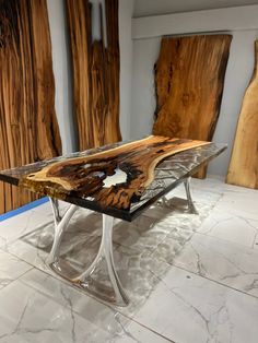 a table made out of wood with metal legs and glass inlays on the top