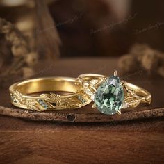 two gold wedding rings with an aqua blue stone