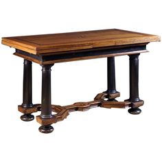 an old wooden desk with two black legs and a wood table top on casteors