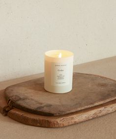 a candle sitting on top of a wooden tray