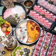 a table topped with lots of food and meats on top of it's sides