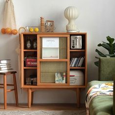 a living room with a book shelf and two stools in front of the bookshelf