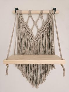 a macrame hanging from a wooden shelf