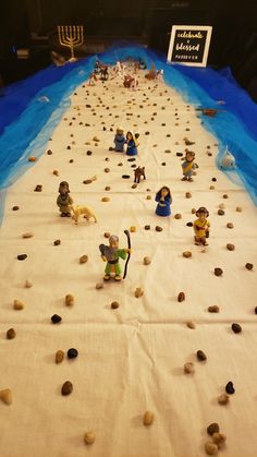 a long table covered in lego figures and rocks