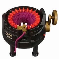 a machine that has some kind of purple thing in it's center and is connected to a yellow cord