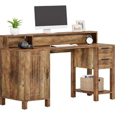 a wooden desk with a computer monitor and keyboard on it's top, sitting next to a wicker basket