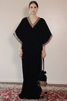 Black Embroidered Kaftan Featuring a blue kaftan in silk velvet base with side slits and lace hand embroidery. This contains one piece only. This product will be shipped to you after 1-2 weeks from the date of order placed. All custom made orders are not returnable. Pls contact for Size chart and for other more colors Request You :To provide contact details for courier services. {VARIATION MAY COME DEPENDING UPON AVALIBILITY OF LACES OR GOTTA PATI} NOTE:  1) Visual Samples on website may differ slightly from actual product due to light & effects during photography (Length & Breadth have 1 n 1.5 inches +/-). 2) Before placing order ,pls confirm product n color availability on +91 7903893945 & +91 8447750028(WhatsApp) 3) For Wholesale Order MOQ is 5 Pieces of any color/Pattern contact on +91 Velvet Kaftan, Kaftan Design, Blue Kaftan, Kaftan Pattern, Berry Dress, Embroidered Kaftan, Kaftan Designs, Independance Day, Dream Wedding Ideas Dresses