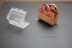 a plastic object sitting on top of a table next to a small piece of wood