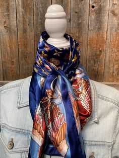 "Our classic wild rag/scarf in a blue color is accented with a multi-floral pattern. It is a square and measures 35\" x 35\". It is sure to add a bright pop of color to any outfit. Western or Crystal slides available to accent 100% machine washable polyester, silky and soft." Blue Bandana Scarf As Gift, Blue Bandana As Gift, Blue Scarves For Spring, One Size, Blue One Size Scarves For Spring, One Size Blue Scarves For Spring, Blue Silk Scarf As Gift, Bohemian Blue Bandana Scarf, Bohemian Blue Scarf Bandana, Blue Shawl Scarf For Gift