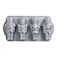 three cookie molds in the shape of santa's soldiers, one with a beard and