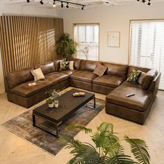 a living room filled with lots of brown furniture