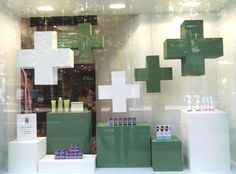 a store window with green and white items on display