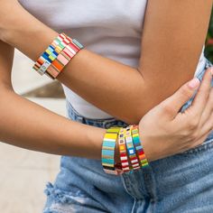 What can be more fun that these colorful, stackable, elastic bracelets? Each tile is handmade with an oil dripping technique and then beautifully arranged to complete the design. Wear just one or stack them all and see all the heads turn. These bracelets are that gift everyone loves to receive. - Care Instructions: Avoid contact with water, lotion, and perfume. Clean gently with a polishing cloth. Product Specifications: - Adds a touch of color to your wrist - Handcrafted with love and care - Ea Casual Multicolor Stackable Friendship Bracelets, Playful Multicolor Stackable Bracelets, Trendy Multicolor Stackable Stretch Bracelet, Multicolor Stacked Bracelets As Gift, Multicolor Stackable Stretch Bracelet As Gift, Perfume Clean, Tile Bracelet, Gold Tile, Elastic Bracelets