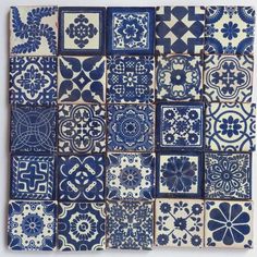 blue and white tiles are arranged in rows on the wall, with different shapes and sizes