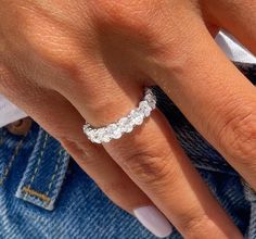 a woman's hand with a diamond ring on it