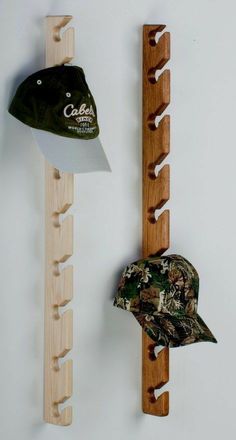 two hats and a hat rack are hanging on the wall