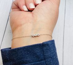 This dainty and beautiful sterling silver bracelet has 3 CZ gemstones and the ashes are secured behind the stones as shown in the photo above.  PLEASE SEND YOUR ASHES WITHIN 2 WEEKS OF PLACING YOUR ORDER. IF I DO NOT RECEIVE THEM IN A TIMELY MANNER YOUR ORDER MAY BE CANCELLED AND YOU MAY NEED TO REORDER. **These are for pet/animal ashes. Etsy's policy does not allow jewelry made with human cremains. If you would like these made with human ashes, please visit my website... Soul-Impressions.com  * Dainty Three-stone Jewelry Gift, Silver Diamond Bracelet With Bezel Setting For Gift, Pet Ashes Jewelry, Cremation Bracelet, Memorial Jewelry Ashes, Cremation Ring, Pet Jewelry, Cremation Necklaces, Bracelet Stone