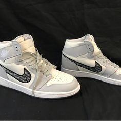 Elevate Your Sneaker Game With These Nike Dior Air Jordan 1 High Tops, Part Of The Limited Edition 2020 Release. With A Sleek White Color And High Top Style, These Athletic Shoes Are Perfect For Any Casual Or Sporty Occasion. The Shoe Features A Uk Shoe Size Of 9, Us Shoe Size Of 10, And Eu Shoe Size Of 37.5, Ensuring A Comfortable Fit For Any Foot. These Air Jordan 1s Are Made With High-Quality Materials And Crafted With Precision To Ensure Durability And Longevity. They Are A Must-Have For Any Luxury High-top Jordan Shoes, Designer High-top Jordan Shoes With Branded Insole, Designer Low-top Jordan Shoes, Jordan 1 High Tops, Air Jordan Dior, Jordan 1 High Top, Air Dior, Air Jordan 1s, Preppy Shoes