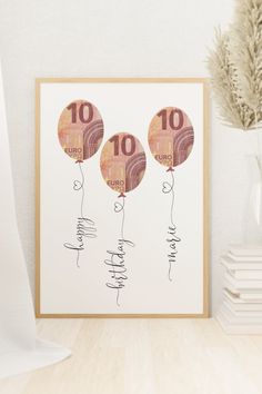 three balloons with the number ten on them are in front of a white vase and some books