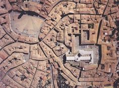 an aerial view of a large city with lots of buildings and streets in it's center