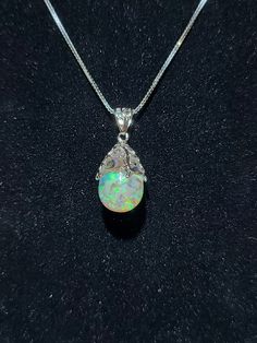 Genuine natural floating opal sterling silver necklace! This piece is made using a 14x11 tear drop crystal clear glass filled with Natural Raw opals and kyocera opals that have flashes of green light then oil is added to give depth and shine! Both the leaf cap and clasp are Pure sterling silver! The 20inch chain is pure sterling silver with a rhodium coating to prevent tarnishing and give extra shine! Every part of this pendant is made using pure solid sterling silver including the main chain. - Opal Pendant Necklace, Raw Opal, Opal Pendants, Opal Necklace, Green Light, Tear Drop, Sterling Silver Necklace, Crystal Clear, Sterling Silver Necklaces