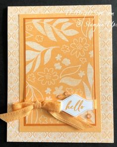 an orange and white card with a bow on it