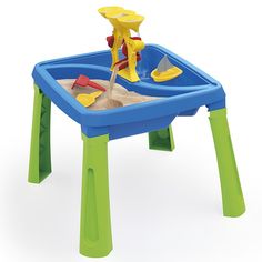 a child's sand and water table with toys in it on a white background