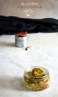 a jar filled with pickles sitting on top of a table