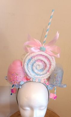 Lollipop and Cotton Candy together!! 💞 This lollipop headband can be made to fit kids and Adults!!  Choose from either a light blue headband or light pink.  🍭 The lollipop is done in two shades, light pink and light blue.  With white swirls and chunky glitter that is sealed.  🍭 The lollipop will have a straw/stick ( the stick is inside the straw for extra durability ) on top and a satin pink bow. 🍭 The two mini cotton candies are in light pink and light blue and come with  Colorful sprinkles and glitter.    🍬🍬 You will also find some adorable fake candies.   The fake candies will vary. 🍭 The lollipop portion measures 5 in high and wide.     If you measure to the tippy top of the stick it is approximately 11 inches high. Each one is made with care and the cotton candies are also hand Cotton Candy Vendor Costume, Candyland Headband, Baby Cotton Candy Costume, Candy Hair Accessories, Cotton Candy Wig Diy, Cotton Candy Headband, Lollipop Costume, Tooth Costume, Big Headbands