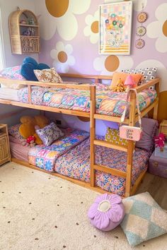 there is a bunk bed in the room with polka dot wall paper on the walls