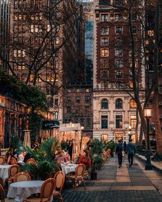 people are sitting at tables in the city