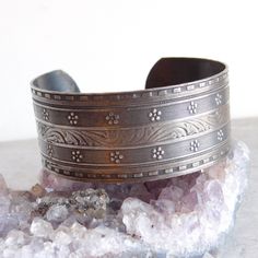 Elaborately engraved silver plated cuff bracelet is in a Victorian style with a central band of acanthus leaves flanked by bands of tiny ridges, flowers, milgrain engraving and a dentille border. The engraving is definitely a cut above what is normally seen on this type of bracelet. It has a lovely, lightly tarnished patina. Size: About 7 interior circumference (including the gap) and 1 inch wide. Age: Unknown, but my hunch is about 1970s, when Victorian style was very popular. Materials: Silver plated base metal. Not attracted to a magnet. Marks: Unmarked Condition: Excellent pre-owned condition. Light tarnish. Plating is in good condition, no bare spots. SHIPPING INFO: This item ships for free to the United States. I use Calculated Shipping for international orders. If I can ship for les Engraved Cuff, Acanthus Leaves, Victorian Revival, Sterling Silver Brooch, Acanthus Leaf, Sterling Silver Cuff Bracelet, Hinged Bracelet, Silver Engraving, Silver Brooch