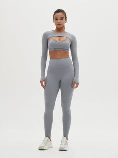 Elevate your activewear wardrobe with the Odette Long-Sleeve Super Crop Top & Sports Bra Set. This unique set combines a stylish super crop top with a supportive sports bra, offering both functionality and fashion. The long sleeves and super crop design provide a chic look, while the sports bra ensures maximum support during your workouts. Perfect for yoga, gym sessions, or casual wear, this set is designed for comfort and performance. Embrace a blend of style and support with the Odette Long-Sl Fitted Gray Crop Top For Workout, Sporty Gray Stretch Crop Top, Gray Stretch Crop Top For Workout, Medium Support Activewear Crop Top For Yoga, Gray High Stretch Crop Top For Workout, High Stretch Gray Crop Top For Workout, Gray Fitted Sporty Crop Top, Gray Compressive Activewear For Light Sports, Fitted Crop Top Activewear For Workout