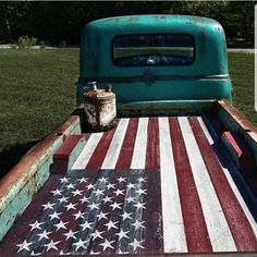 an old truck with the american flag painted on it